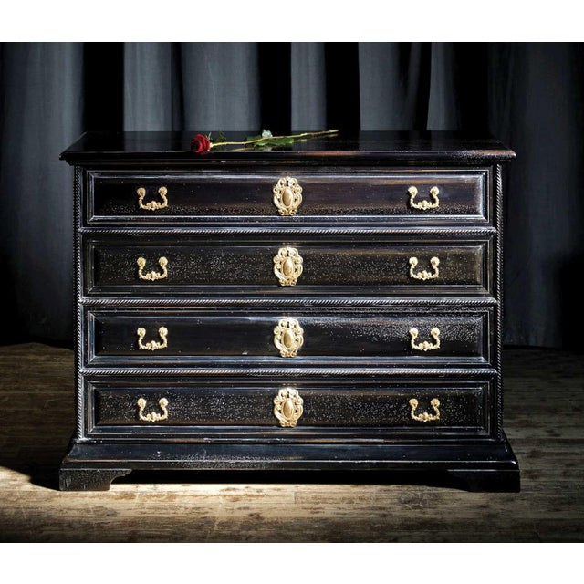 Handcrafted in Italy from solid walnut, this 17th Century Venetian chest features four spacious drawers with solid antique...