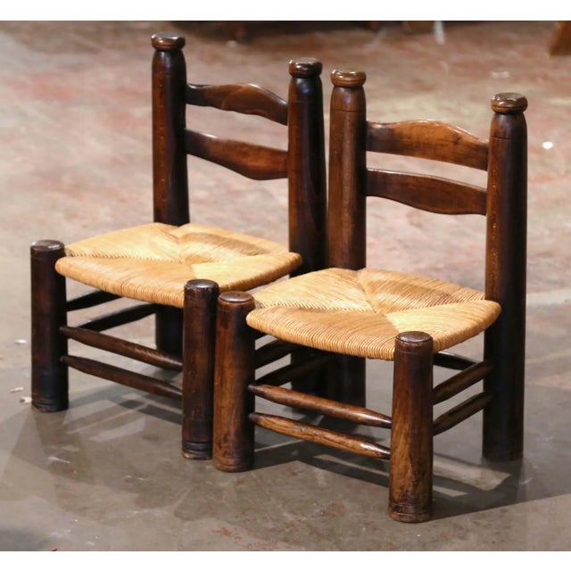 With their low profiles and bold rustic construction, this pair of antique chauffeuse chairs reflects the distinctive...
