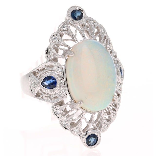 This gorgeous Victorian Inspired cocktail ring has a very large, beautiful Oval Cut Opal that weighs 4.61 Carats. The...