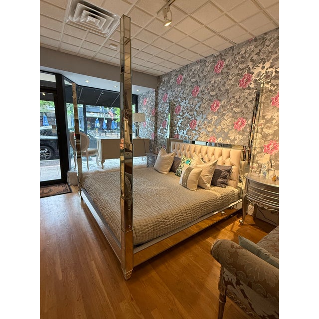 This luxurious four-poster bed frame is a statement piece designed for a high-glamour bedroom. It features a fully...