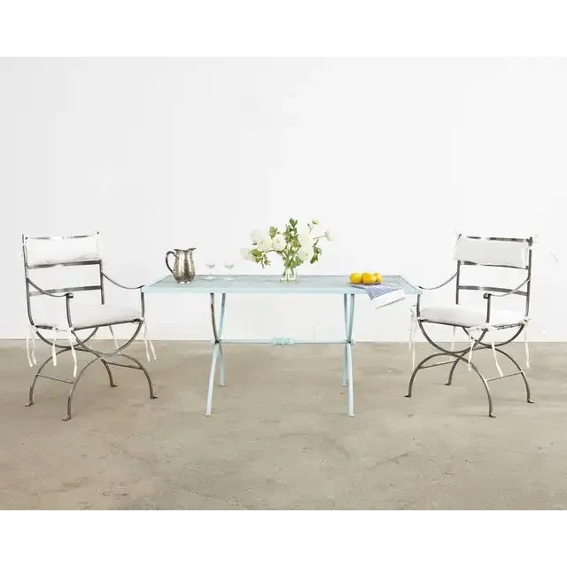 Gorgeous pair of Italian polished steel patio and garden dining armchairs featuring neoclassical style curule legs. Hand-...
