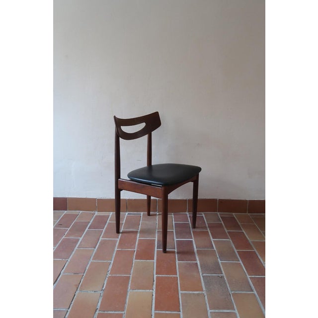 A set of five Danish dining chairs from the 1960s in solid teak, recognisable by their open, cut-out backrests and their...