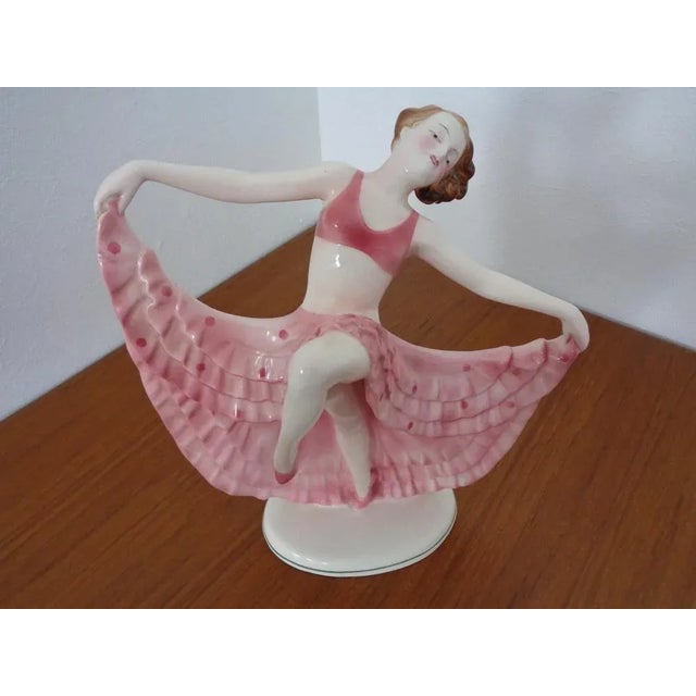 This is an Art Deco dancer from the 1920s. It was manufactured by Hertwig & Co. The dancer is in nice condition without...