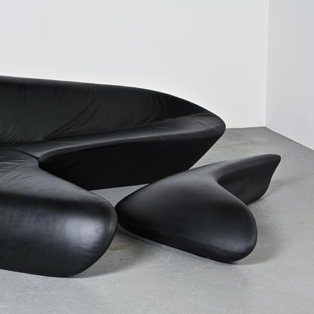 The sculptural "Moon System" sofa, designed by Zaha Hadid in 2007 for B&B Italia. Its silhouette evokes a monolithic...