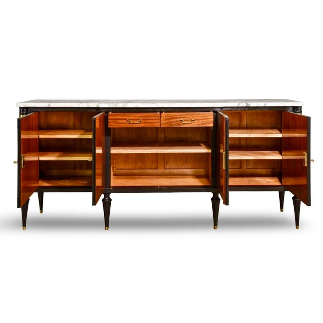 This Louis XVI style black lacquered credenza or sideboard features striking burled walnut cabinet doors. It's framed in...