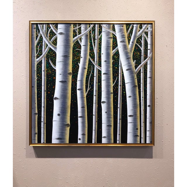 In "Revelry," a serene grove of white birch trees stands tall against a dark, vibrant backdrop filled with colorful specks...