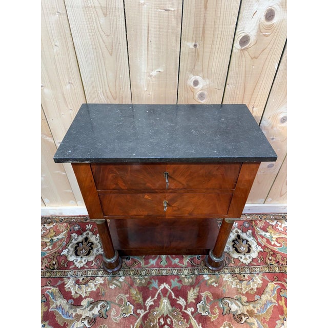 Empire style side table in solid walnut and walnut veneer, dating from the 19th century. This piece is distinguished by...