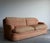A generously scaled A. Rudin sofa with softly rolled arms, a clean plinth base, and deep loose cushions that give it a...