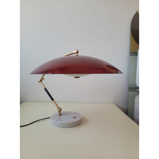 Designed in 1955 and produced by Stilux Milano. Circular base in Carrara marble, brass stem with 3 joints, red acrylic...