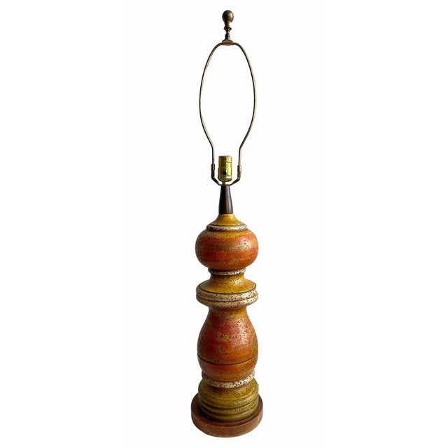 Vintage, mid century table lamp.Textured cast chalk table lamp with orange and yellow finish. Starter shade included.