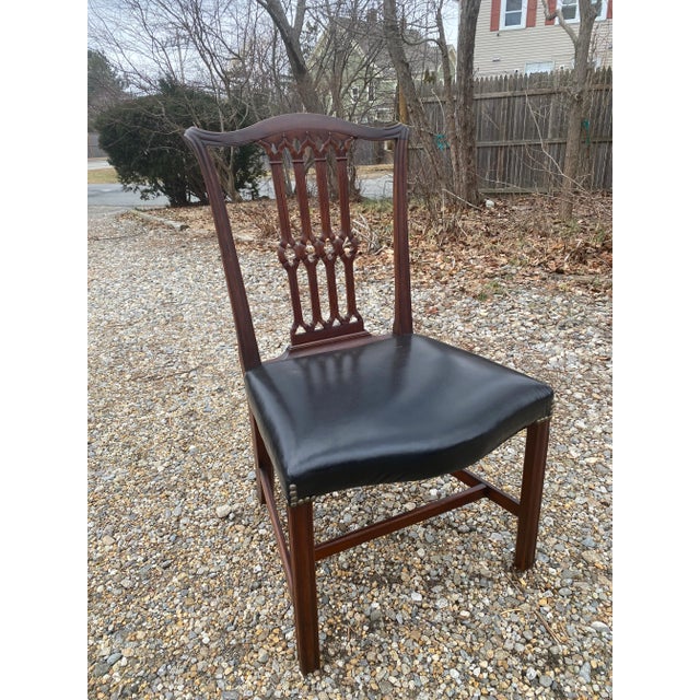 Set of Four Georgian Mahogany Chairs. Finely Carved Carved in the manner of Thomas Chippendale Leather Upholstered Seats....