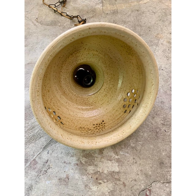 Stylish ceramic pendant light made in Denmark. The lamp is made of orange, brown and beige ceramics and has holes in it,...