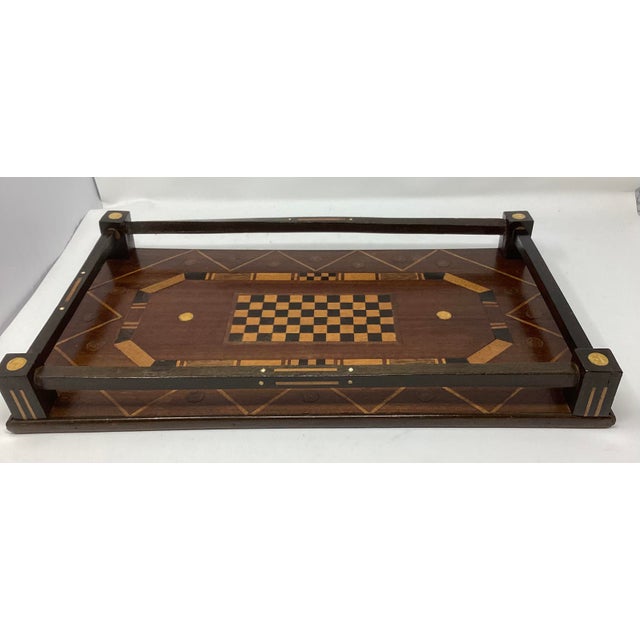 Folk Art Tray with intricately designed game board motif and a wood rail capped with round inlay in contrasting color....