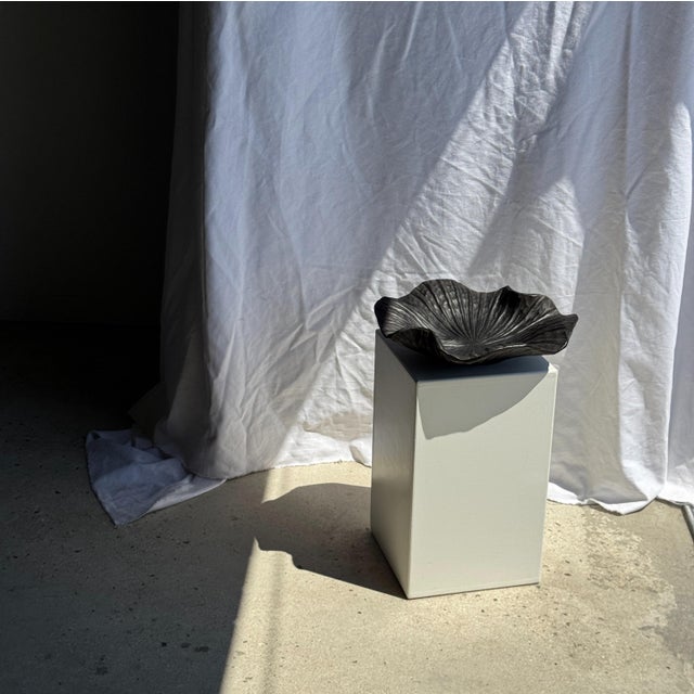 Blackened teak bowl in the shape of a leaf or flower, carved from a single piece of wood. Elegant, organic design,...