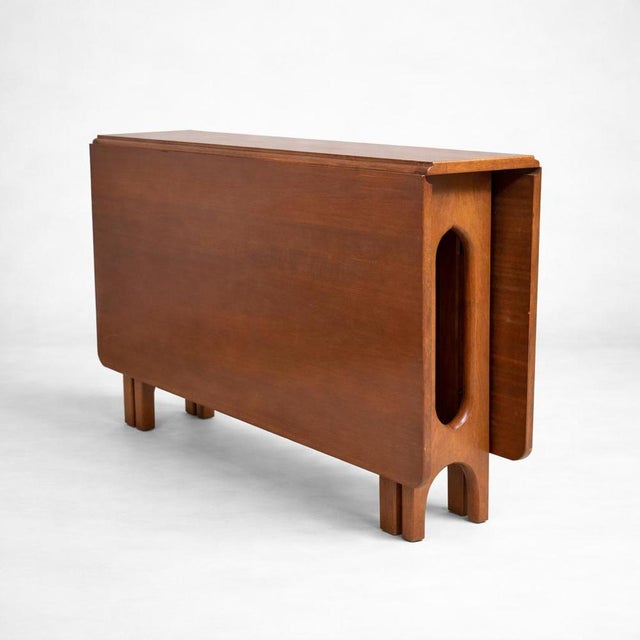 A beautifully designed vintage McIntosh compact drop-leaf dining table, crafted in warm teak and showcasing the clean,...