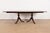 An exceptional Georgian or Regency style double pedestal extension dining table In the manner of Baker Furniture USA,...