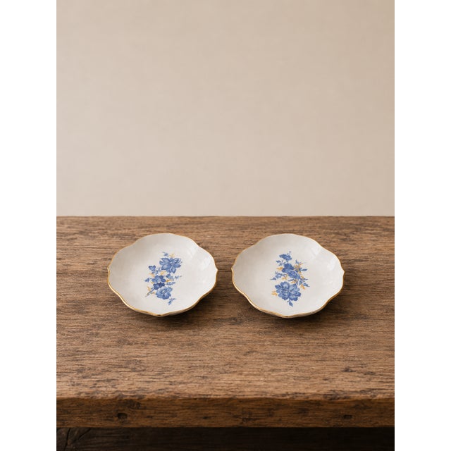 An authentic matching pair of Meissen porcelain bowls of German production, featuring the classic blue floral motif and a...