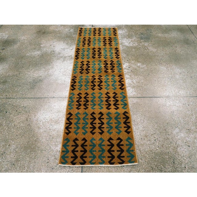 This striking mid-20th century Turkish Anatolian Deco runner, measuring 1' 11" x 6' 6", embodies the spirit of modernist...