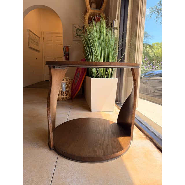 Make a statement with this contemporary sculptural end table, crafted from richly grained wood in a warm walnut-brown...