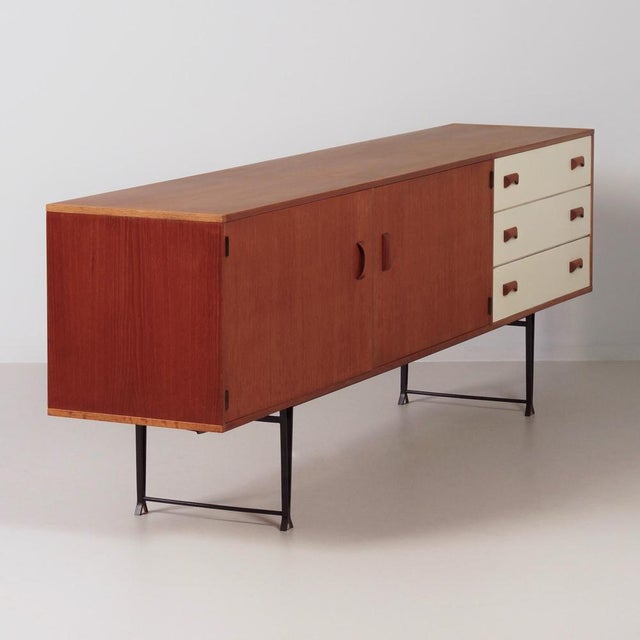The Modulus TL225 sideboard by Fristho was designed in the late 1950s by Kho Liang Ie and is executed in teak veneer with...