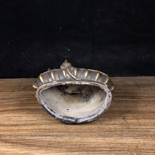 This is a vintage bronze figure of Green Tara, seated in a relaxed pose upon a detailed lotus base. The statue is...
