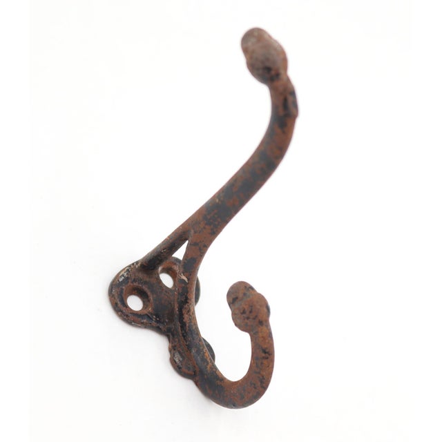 Vintage cast iron double arm acorn wall hook with a black distressed finish. The original mounting screws are not...