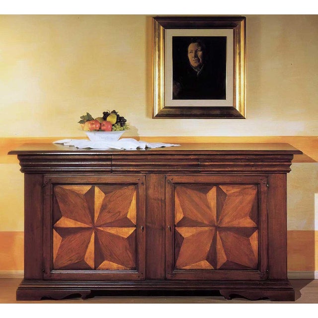 Handcrafted in Italy from solid walnut, this Tuscan sideboard features an antique distressed finish and traditional Old...