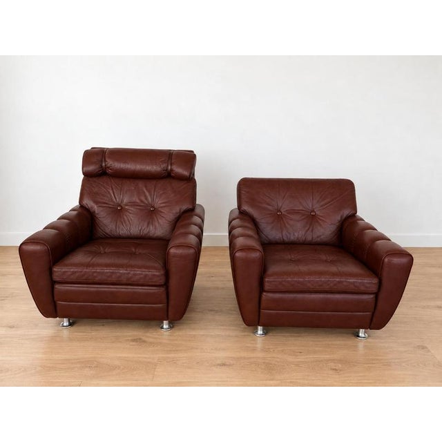 Crafted by Svend Skipper, this exquisite lounge chair set boasts a sleek design and comfort. Upholstered in soft leather,...