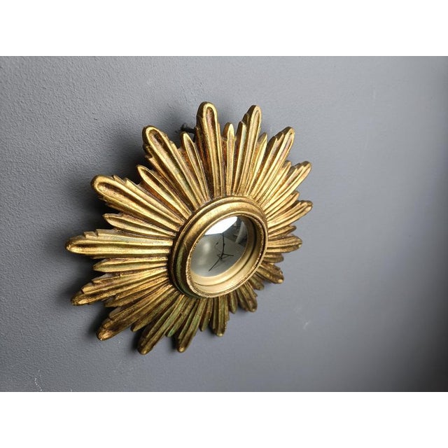 Gilded resin sunburst mirror with convex mirror glass. The golden mirror is in a good condition. 1960s - made in Belgium....
