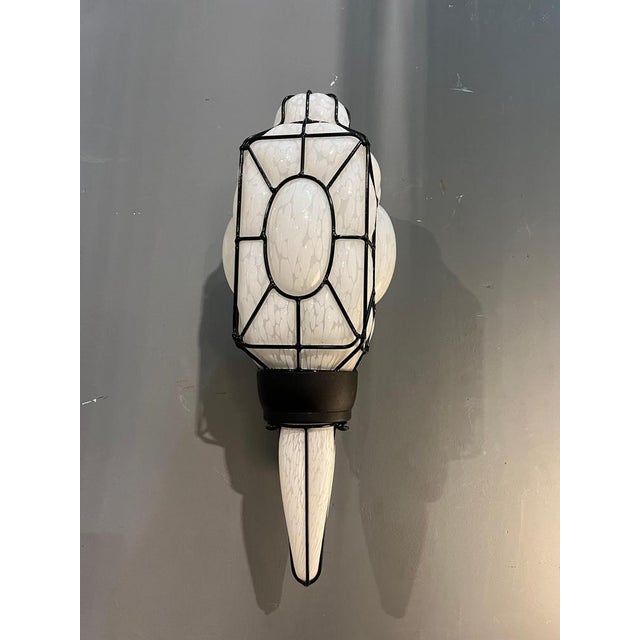 A refined Murano milk glass sconce, crafted in Italy in the second half of the 20th century. The light fixture is composed...