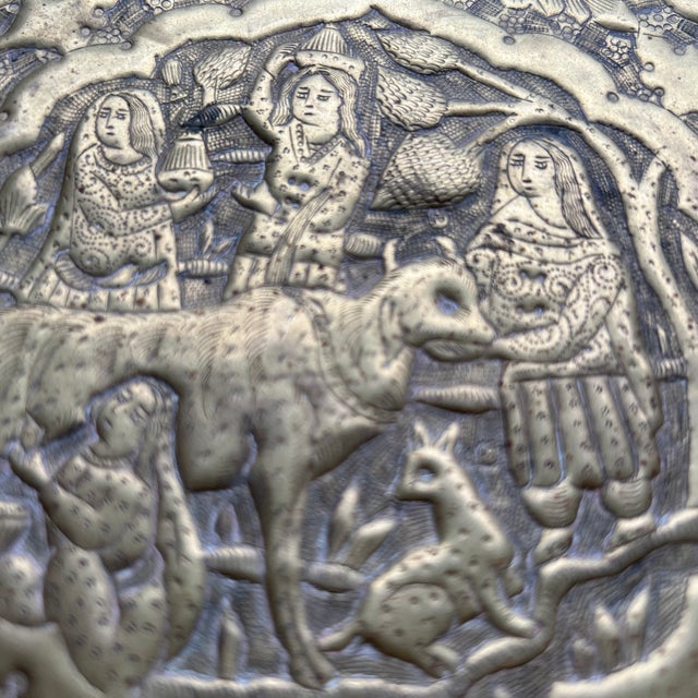 A Persian pastoral scene brass platter is a beautiful and intricate decorative item that would make a great addition to...