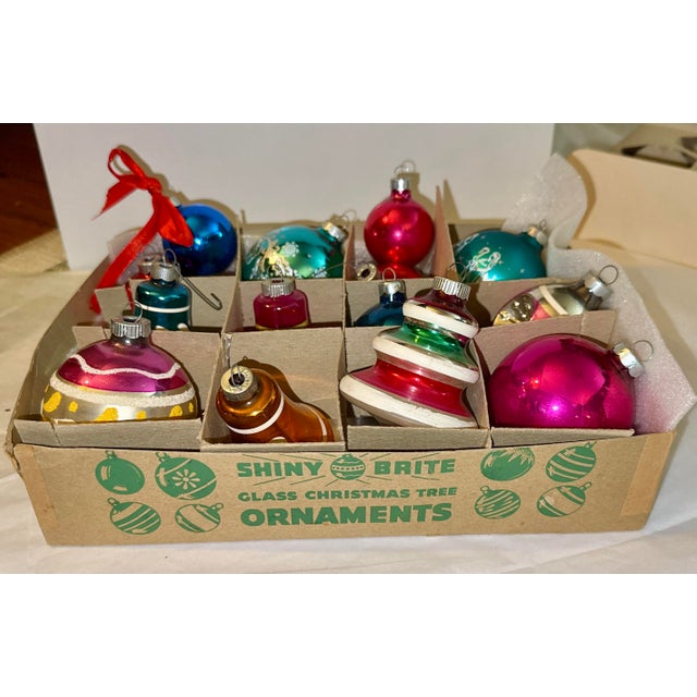Fourteen (14) vintage Shiny Brite mercery glass ornaments. Made between the 1930s and 1950s, this assortment includes a...