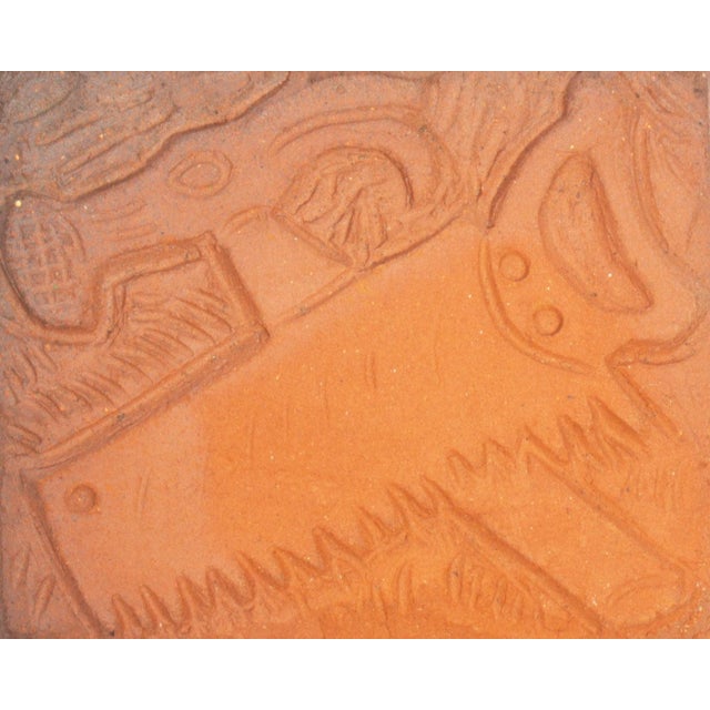 A studio pottery tile by the American artist Mark Bulwinkle (born 1946). This rectangular tile features the impressed...