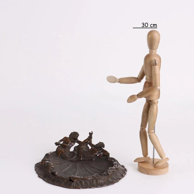 Bowl in embossed and chiseled sheet copper in the shape of a shell with a triton and a centaur in battle. This piece is...