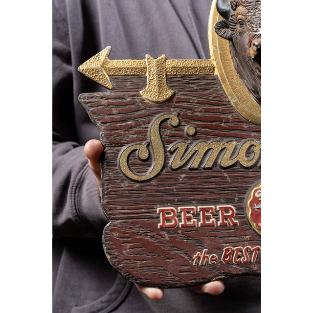 Vintage Simon Pure Beer and Ale advertising sign featuring a deeply textured faux-wood ground with raised lettering and...
