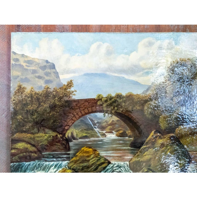 We are selling this charming English folky landscape painting. This simple landscape features an arched bridge over a...