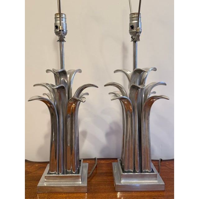 Pair of cast aluminum table lamps in a stylized leaf/palm frond form. These are in working condition with original wiring....