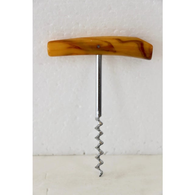 Bakelite-handled stainless steel corkscrew. Marbling creates a faux-tusk look. Minor surface wear to bakelite. No maker's...