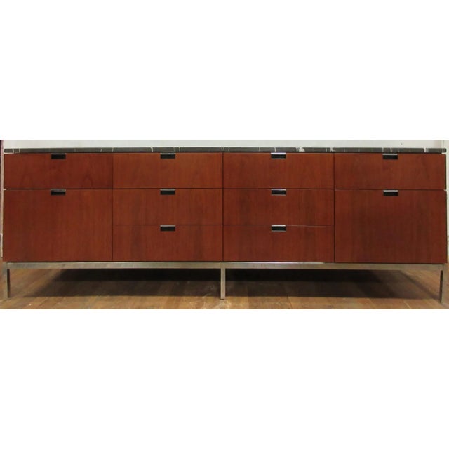 This is a beautiful vintage credenza with a marble top, designed by Florence Knoll International, and manufactured circa...