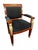 This wooden chair has an upholstered seat and back and features many Neoclassical motifs. From its paw feet to its...