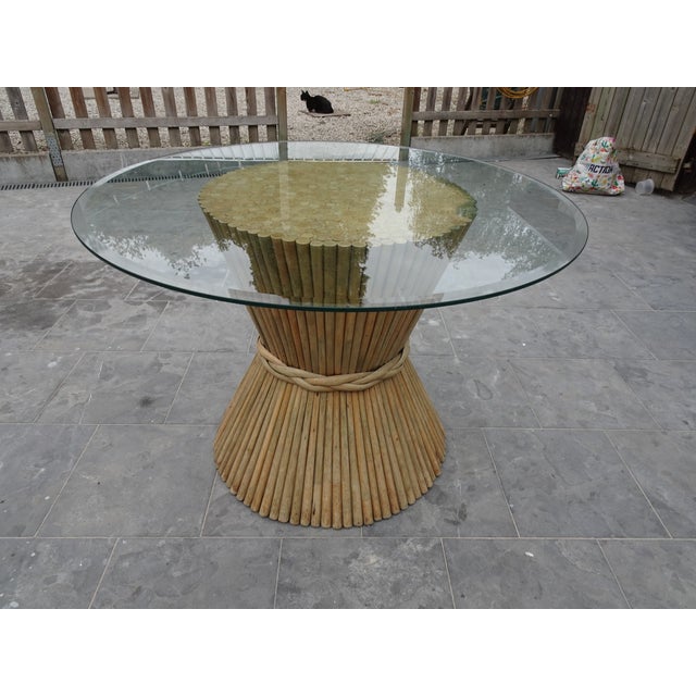 MC Guire Bamboo Rattan and Glass Dining Table, 1970s, in Worn conditions. Designed 1970 to 1979 This piece is attributed...