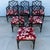 1970s Set of Six Black Chinese Chippendale Style Faux Bamboo Dining Chairs. These chairs are upholstered with a red and...