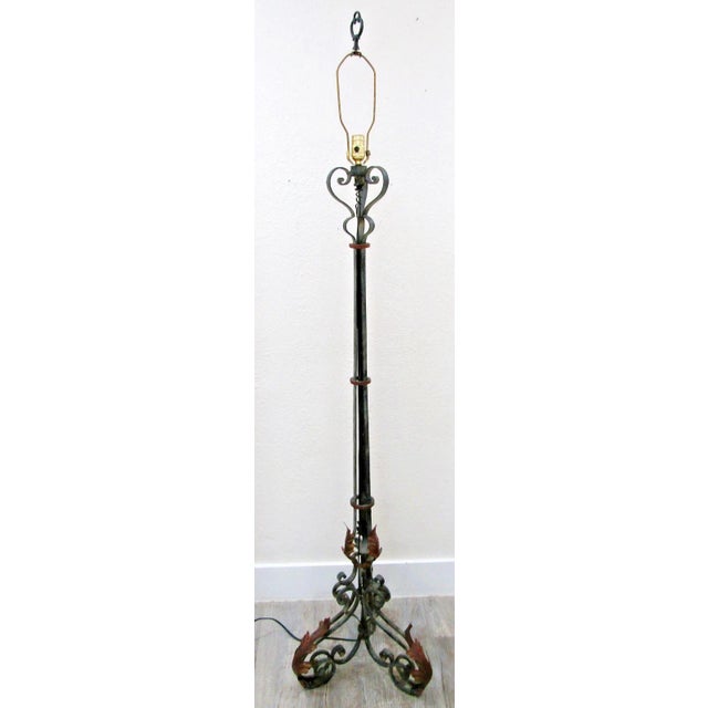 The French Art Deco Wrought Iron Scrollwork and Leaves Tripod Base Floor Lamp is a large, antique original piece dating...
