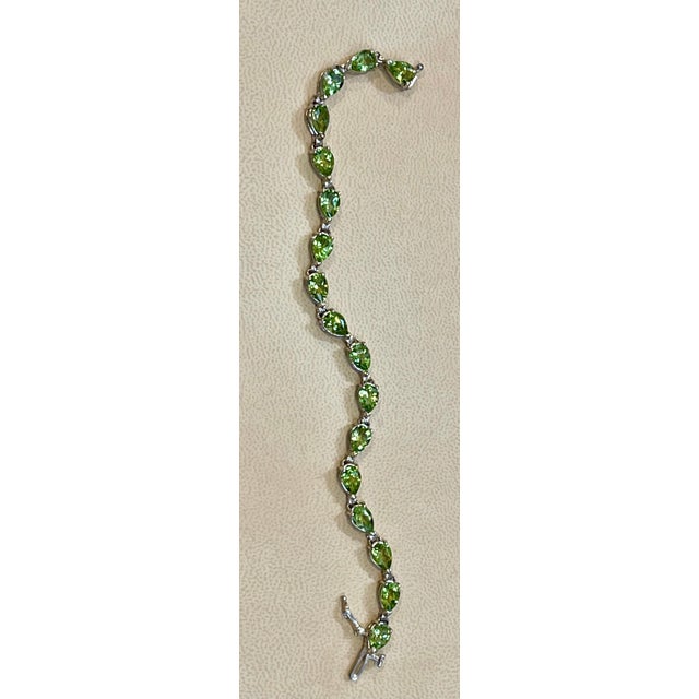 This exceptionally affordable Tennis bracelet has 19 stones of Emerald cut Peridot Beautiful colors , very Vibrant Size of...