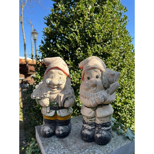 Two old figurines of gnomes, made of ceramics. The paint color has worn off. Yet these timeless items for the garden are...