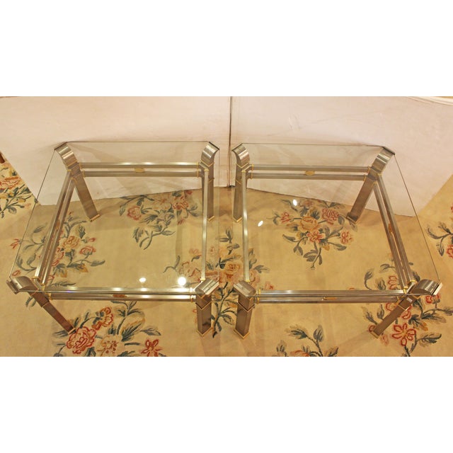 Mid-20th century pair of steel, brass & glass tables. Mid Century Modern. The glass with canted corners within conforming...