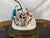A porcelain figural group of three musicians, mounted as a table lamp. A gentleman in a teal coat and patterned breeches...