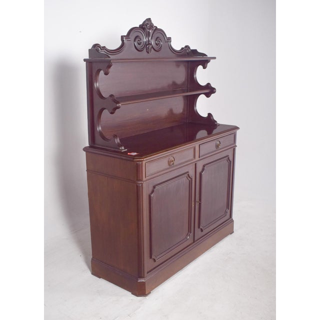 Tall sideboard. In dark wood, it has an imposing and classic presence, with features that evoke Victorian-inspired...