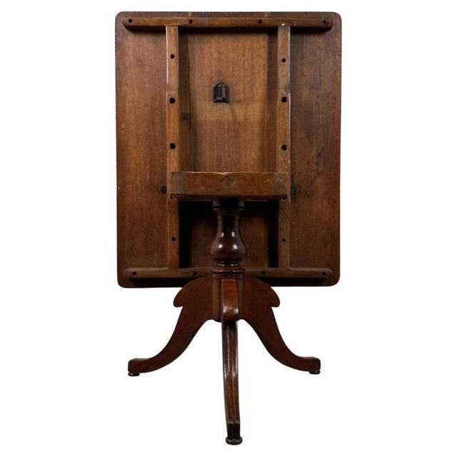 A handsome 19th-century English Victorian breakfast table, finely crafted from oak and distinguished by its practical...