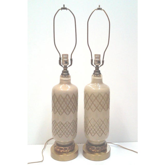 A pair of superb gold Murano cut glass table lamps with gold flecks throughout the opaque glass, These elegant lamps have...